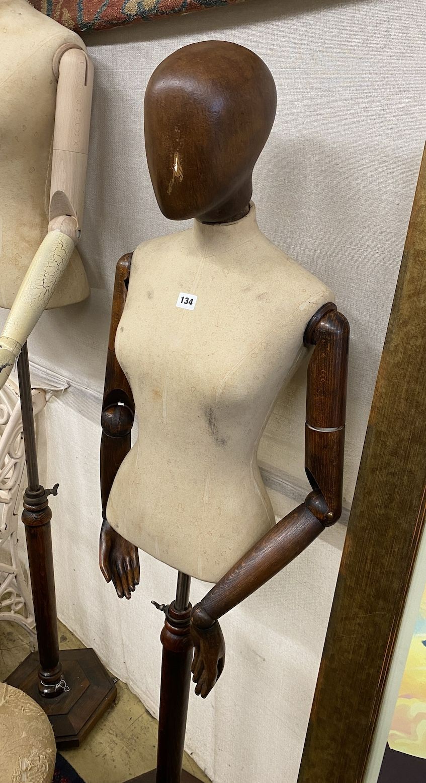 A Victorian style stained beech mannequin on telescopic stand